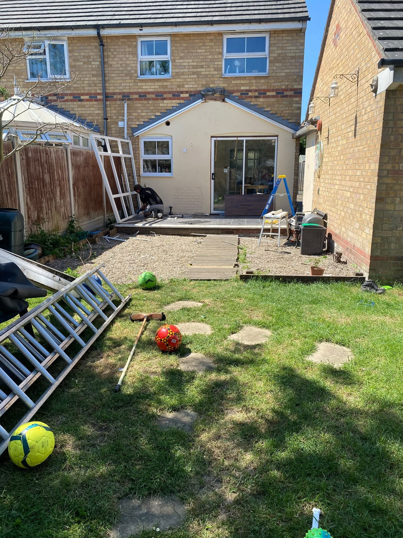 The back garden before work started: old rear wall, patio and lawn