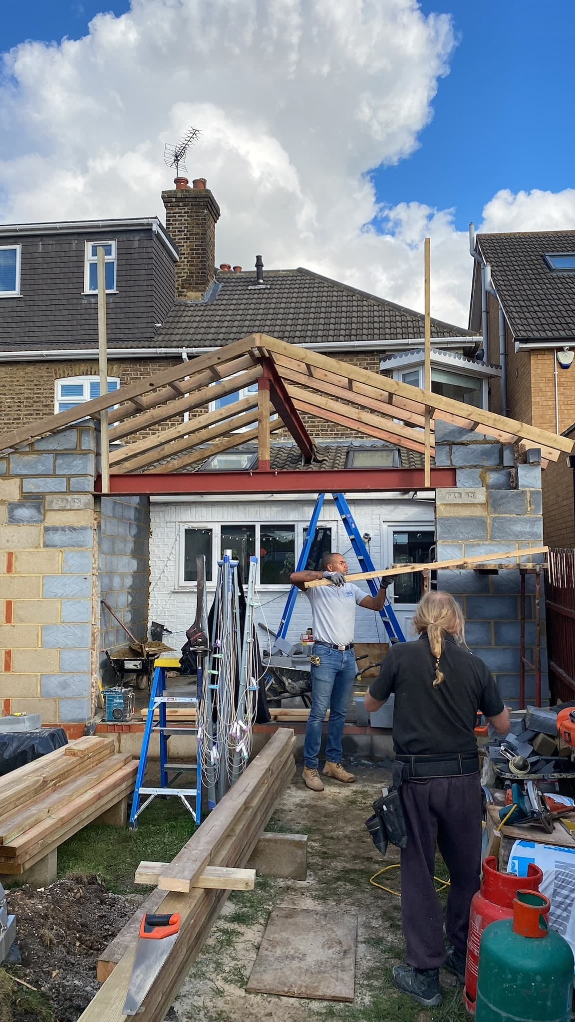 Roof timbers going on with two of the team on the extension