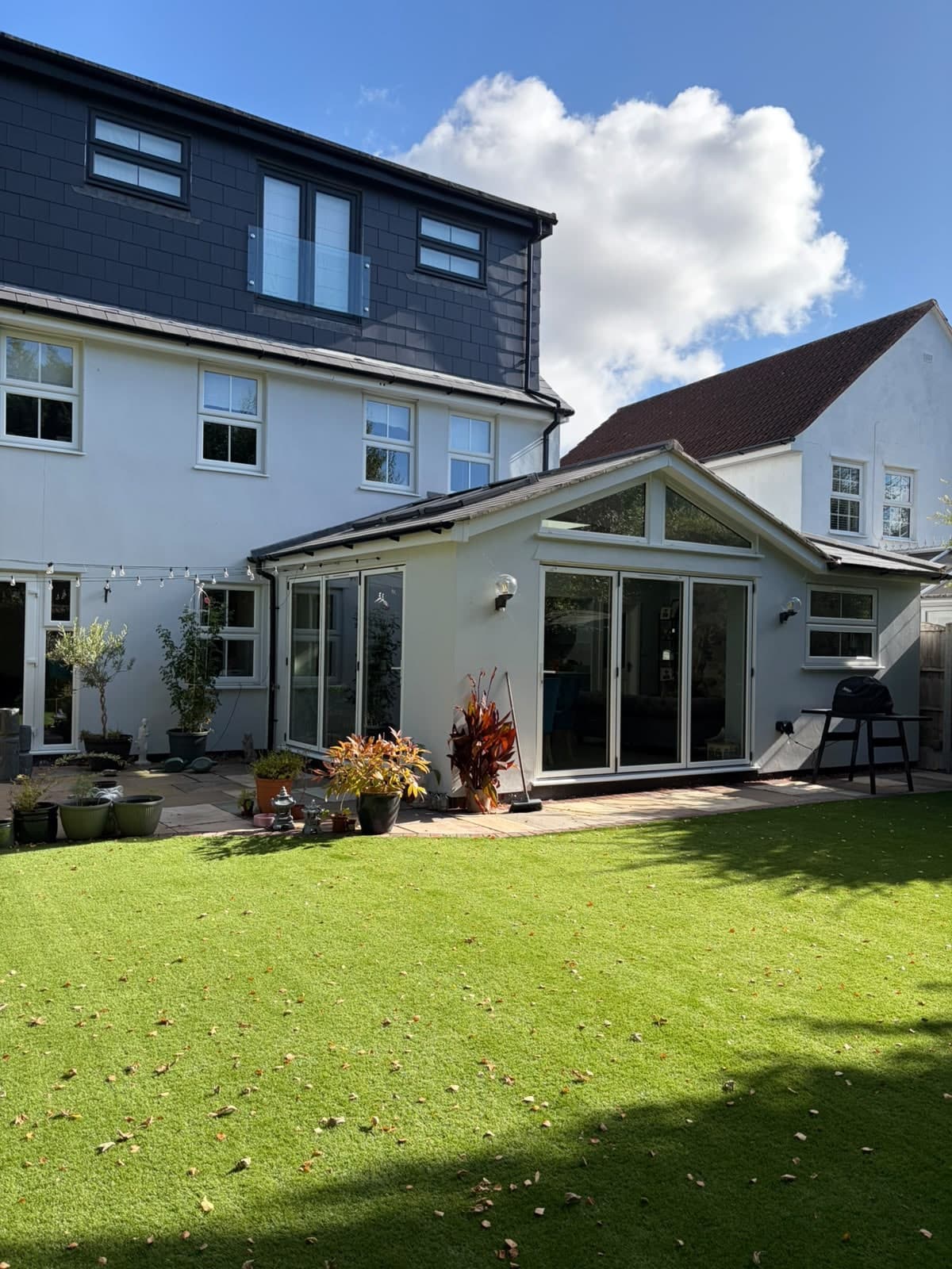 Rear extension with a glazed gable and bi-fold doors opening onto the lawn