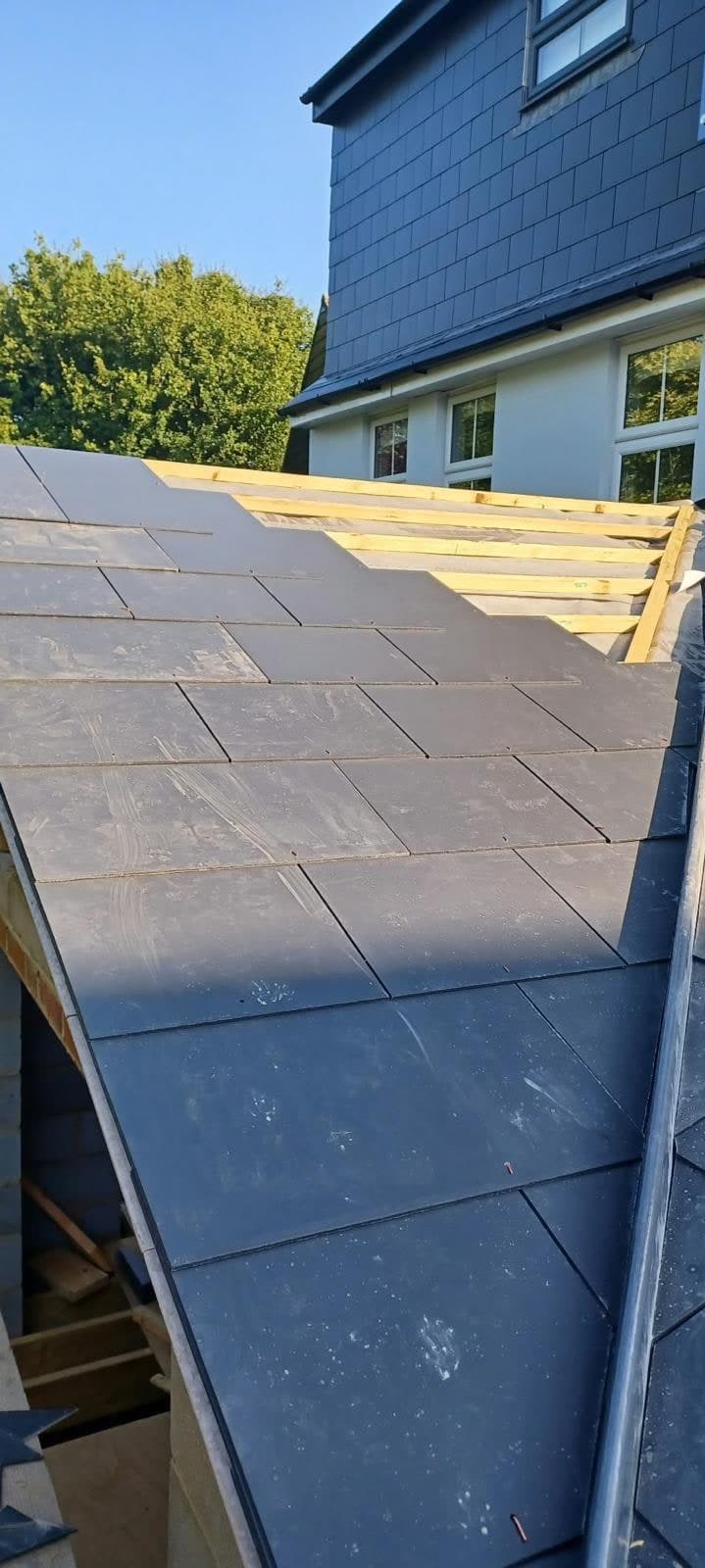 Slate roof half laid on the extension