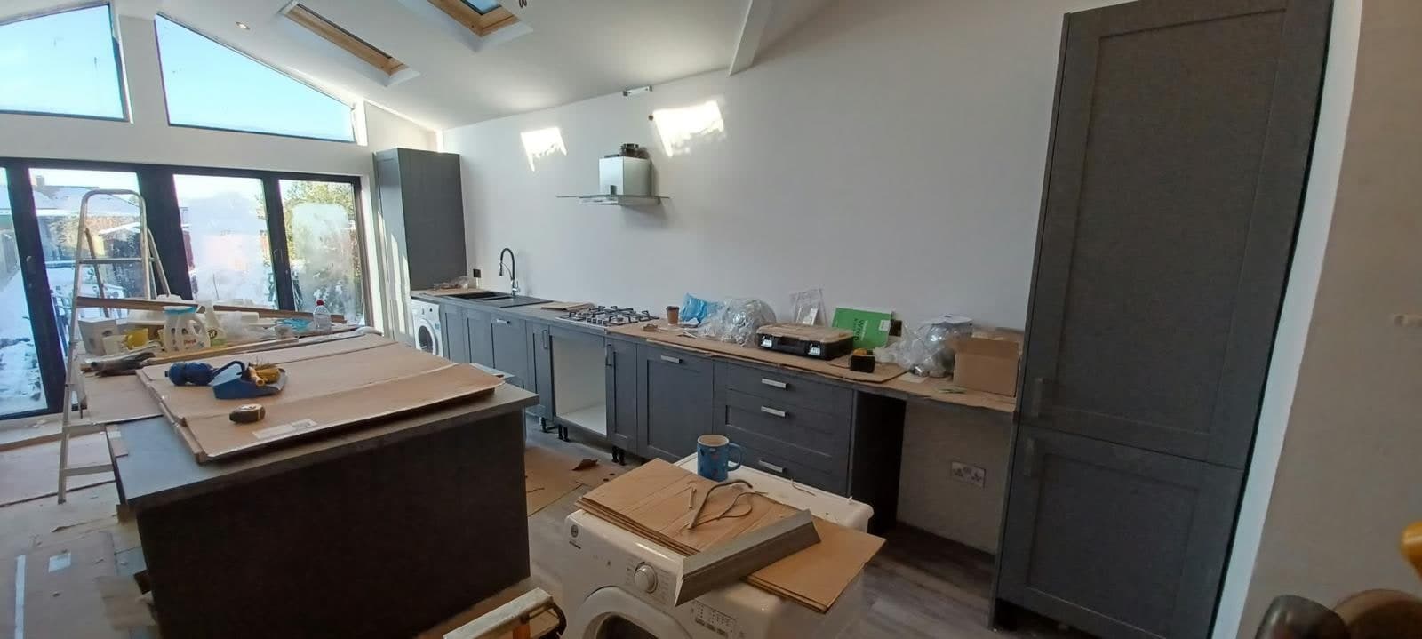 Long run of grey shaker units being fitted