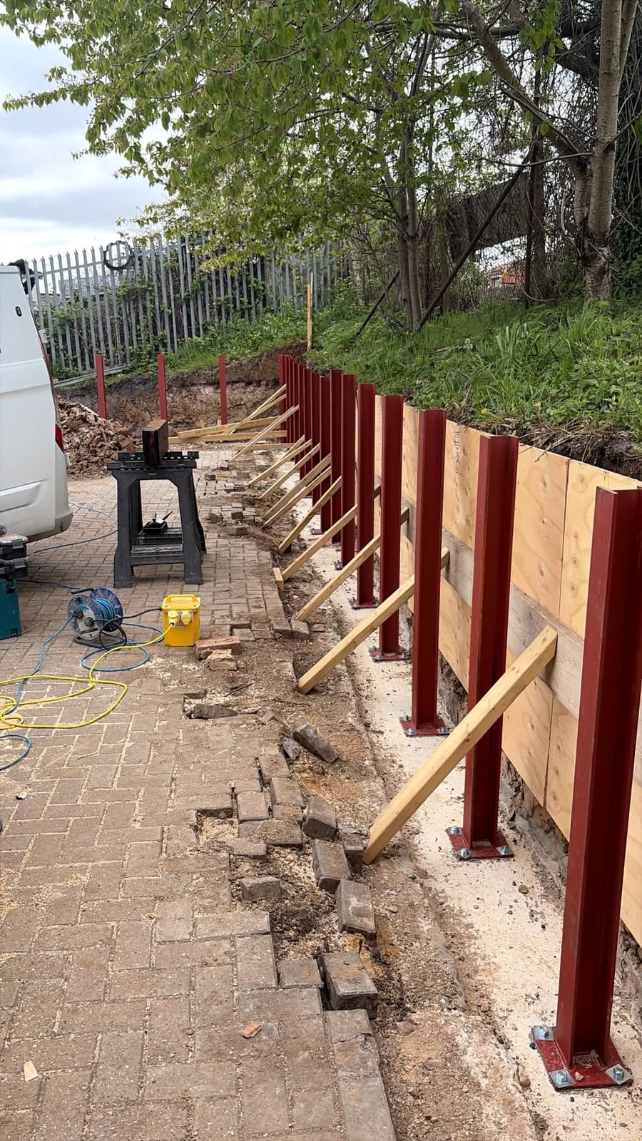 Steel posts set for a sleeper retaining wall