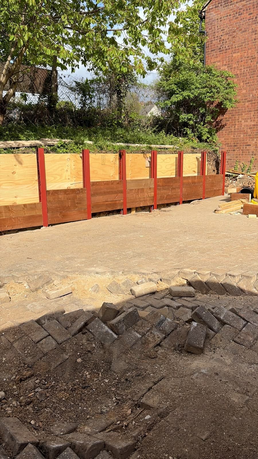 Sleeper retaining wall built, paving to follow