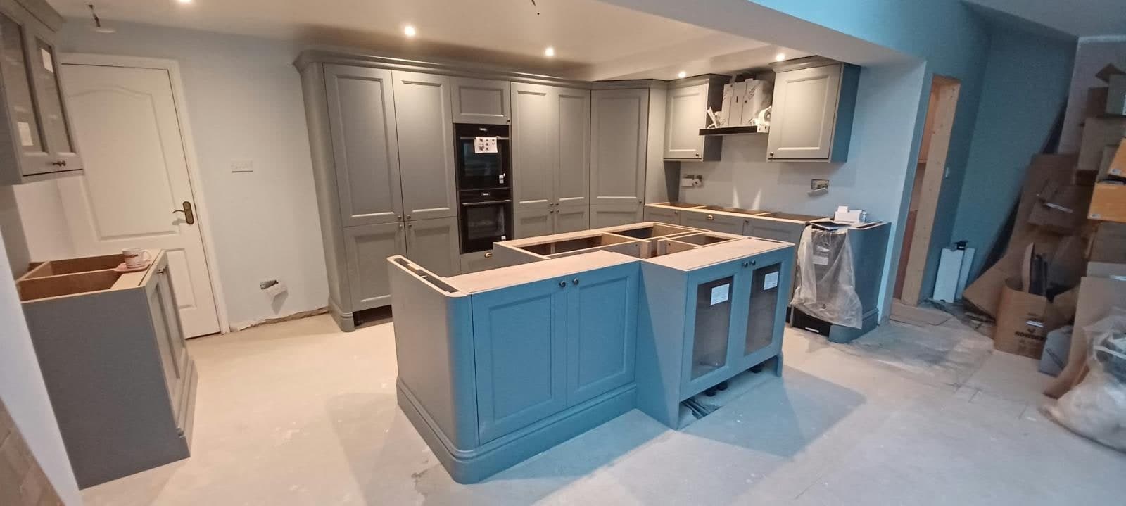 Grey shaker units with the navy island in