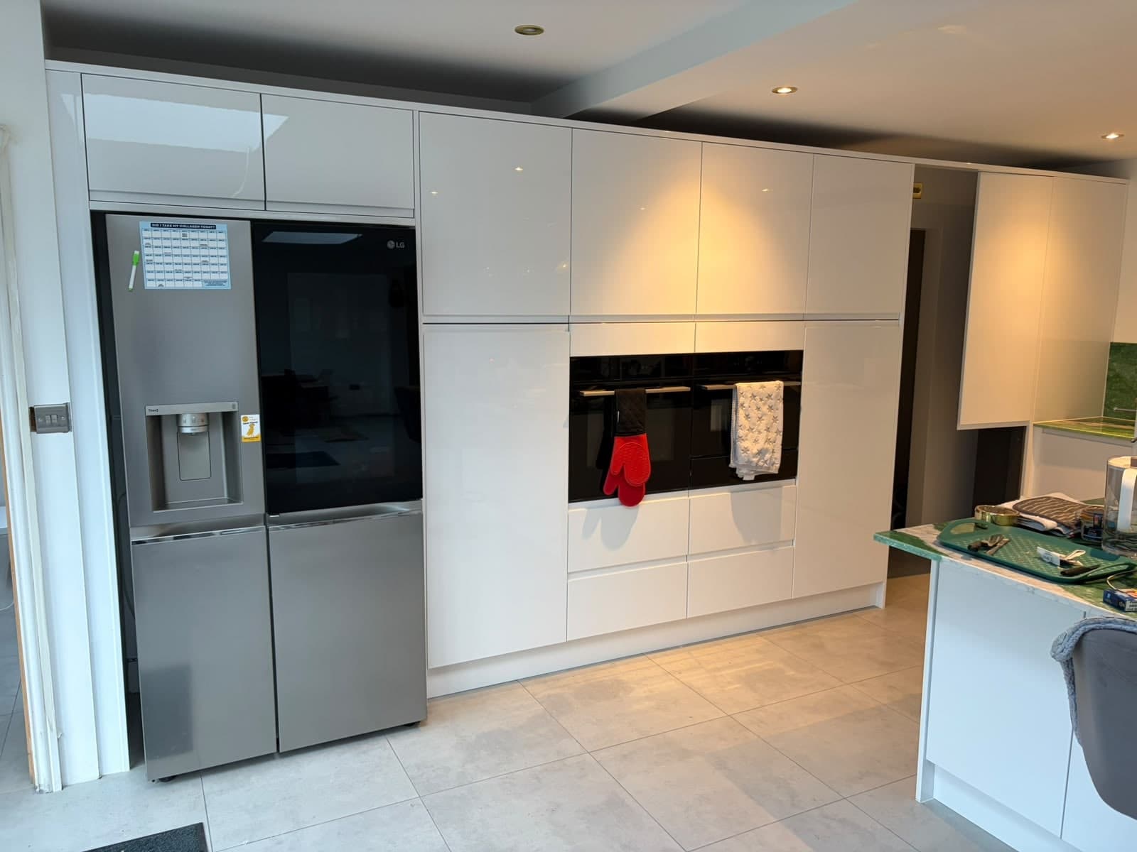 White gloss units with integrated ovens