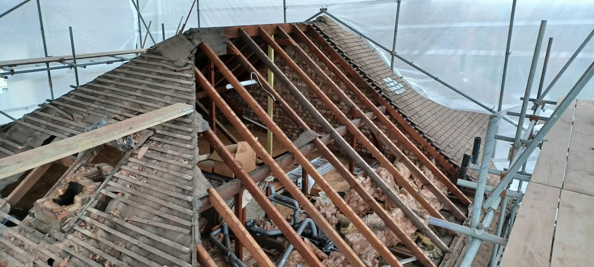 Old roof stripped back to the rafters