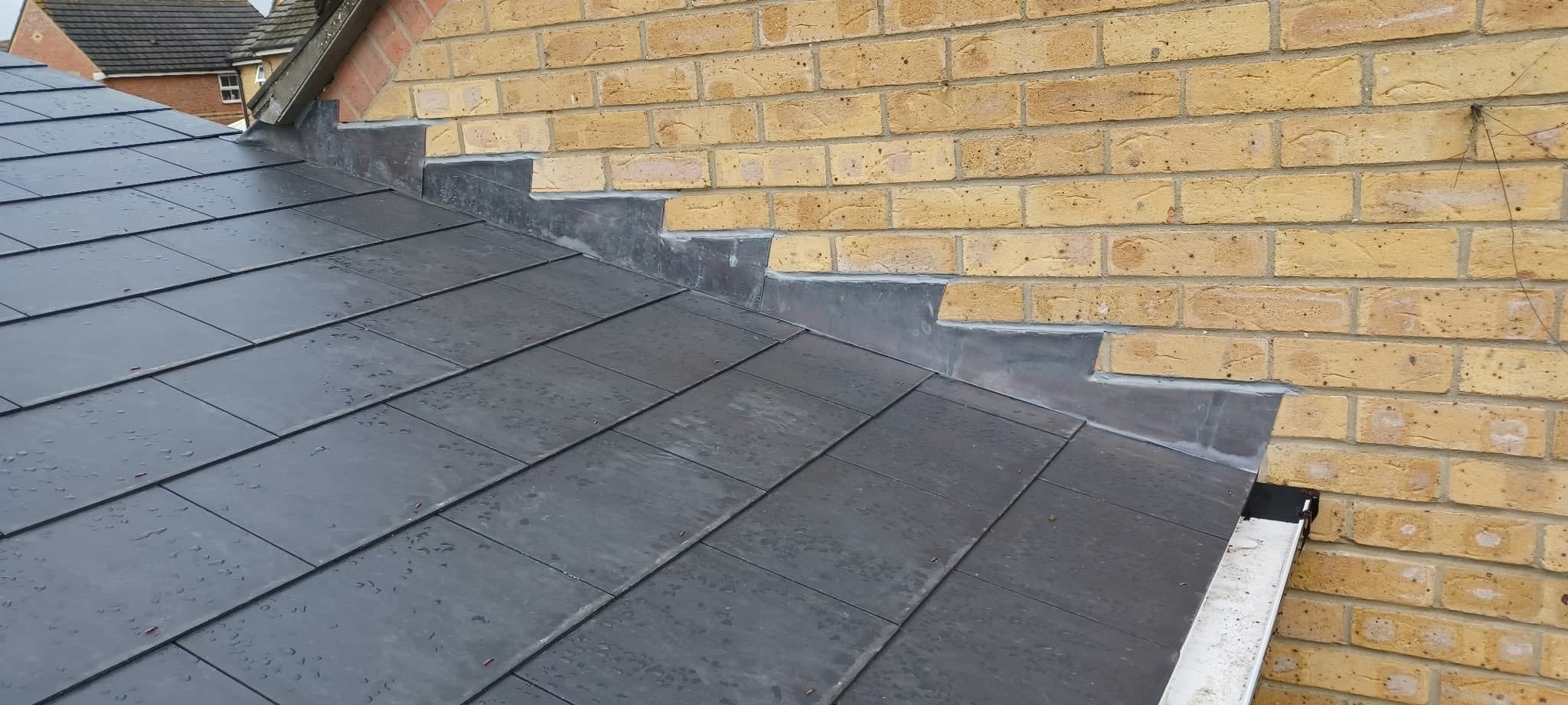 Slate roof finished against the brick gable