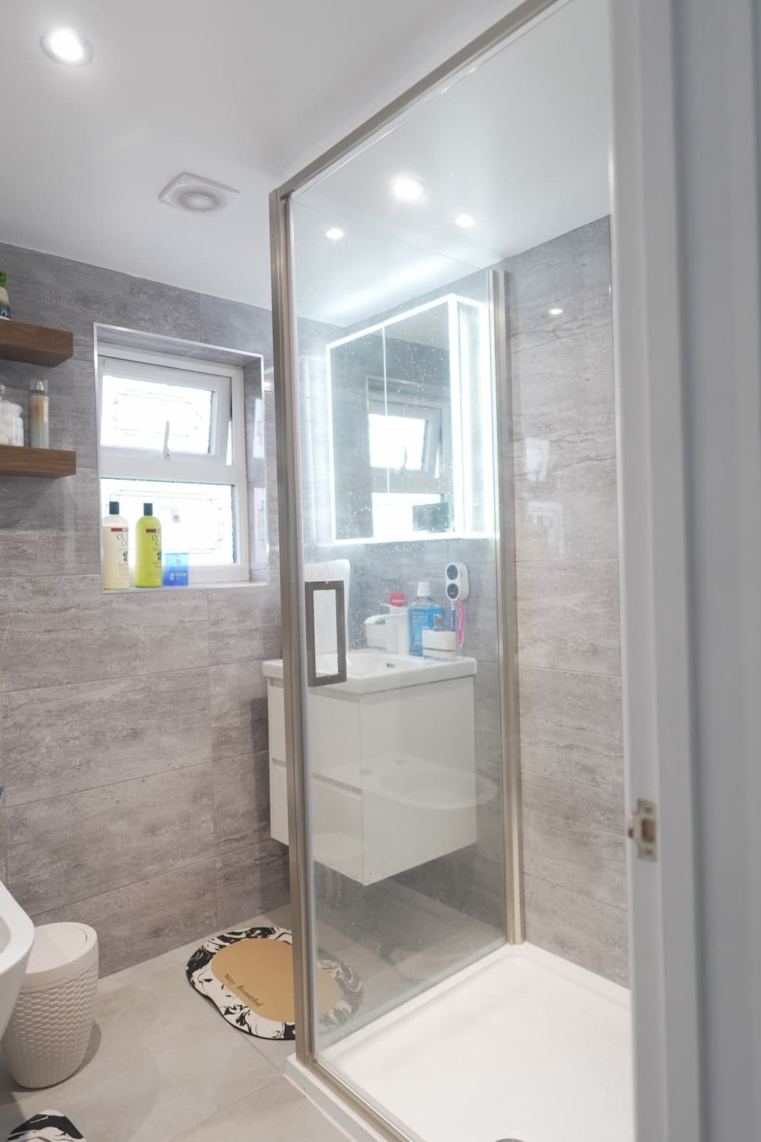 Loft en-suite with walk-in shower and grey tiles