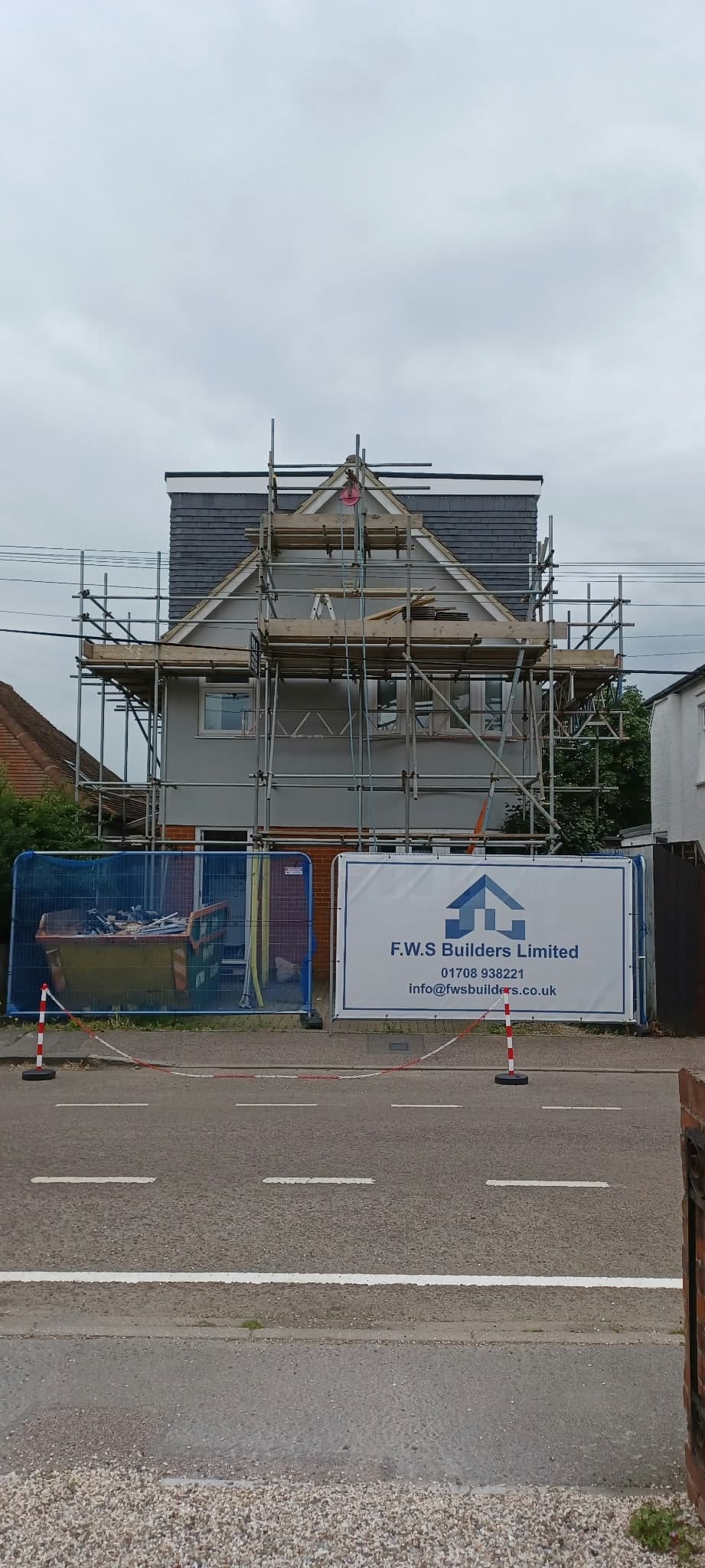 Scaffold and F.W.S banner at the front of a house